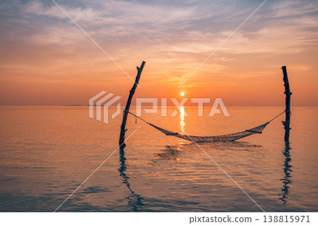 Gorgeous sunset ocean calm water hammock warm sunlight horizon serene summer beach travel relaxing tropical paradise background Gorgeous sunset ocean calm water hammock warm sunlight horizon serene summer beach travel relaxing tropical paradise background 138815971