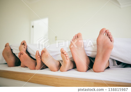 Feet, sleep and family in a bed relax, resting and enjoying a weekend nap in their home. Sleeping, foot and children with parents in bedroom for dreaming, stress relief or vacation freedom in a house Feet, sleep and family in a bed relax, resting and enjoying a weekend nap in their home. Sleeping, foot and children with parents in bedroom for dreaming, stress relief or vacation freedom in a house 138815987