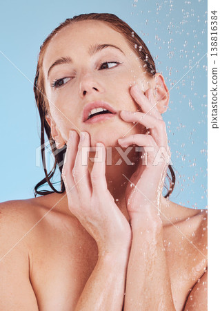 Skincare, shower and girl with cleaning for self care or hygiene in studio or blue background. Woman, washing and water drops for beauty routine to relax or dermatology for hydration and wellness. Skincare, shower and girl with cleaning for self care or hygiene in studio or blue background. Woman, washing and water drops for beauty routine to relax or dermatology for hydration and wellness. 138816384
