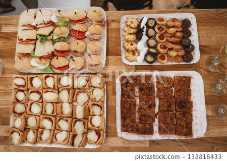 Assorted Finger Foods and Pastries on Wooden Table Assorted Finger Foods and Pastries on Wooden Table 138816433