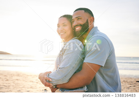 Hug, beach and couple with love, sunset and marriage with happiness, summer holiday and relationship. Romance, happy man and woman embrace, seaside vacation and relationship with a smile and travel 138816483