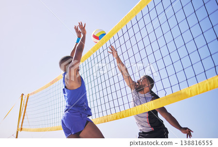 Jump, hit and beach, volleyball and men at net with sports action, fun and summer competition with blue sky. Energy, ocean games and volley challenge with athlete hitting ball for goal in nature. Jump, hit and beach, volleyball and men at net with sports action, fun and summer competition with blue sky. Energy, ocean games and volley challenge with athlete hitting ball for goal in nature. 138816555