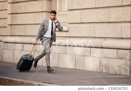 Business man, running late and phone call with travel commute in city for work. Urban, road and professional person with mobile networking and stress in a street with entrepreneur and luggage Business man, running late and phone call with travel commute in city for work. Urban, road and professional person with mobile networking and stress in a street with entrepreneur and luggage 138816701