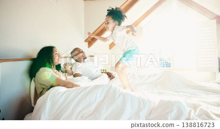 Kid, jump and bed with parent with happiness for bonding with games on weekend for fun in home. Playful, energy and girl with family in morning for quality time with excited child and wake up. Kid, jump and bed with parent with happiness for bonding with games on weekend for fun in home. Playful, energy and girl with family in morning for quality time with excited child and wake up. 138816723