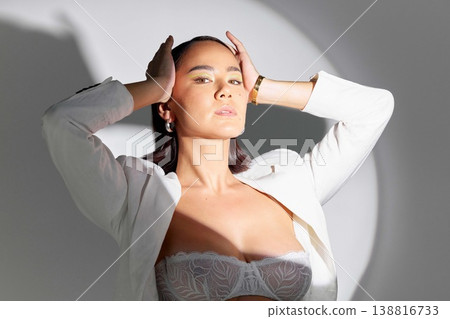 Fashion, spotlight and portrait of asian woman for beauty, classy style and fancy outfit. Young female model, elegant clothes and glamour in white suit with shadow, lighting and studio background Fashion, spotlight and portrait of asian woman for beauty, classy style and fancy outfit. Young female model, elegant clothes and glamour in white suit with shadow, lighting and studio background 138816733