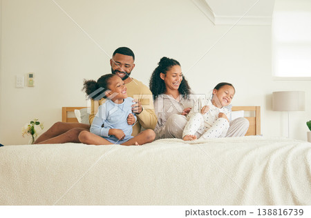 Family, fun and children in morning in bedroom for happiness in home for bonding with love. Playful, mother and father with kid together on bed for laughter for quality time with care with youth. 138816739