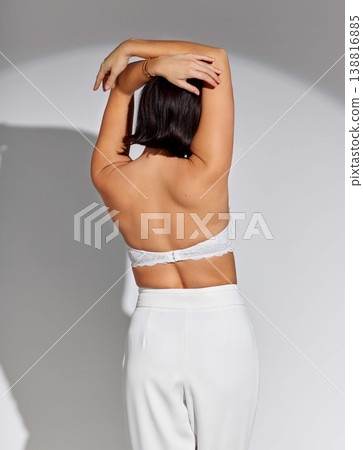 Beauty, fashion and spotlight with back of woman in studio for makeup, creative and art. Design, glamour and luxury with female model on white background for elegant, trendy and aesthetic style Beauty, fashion and spotlight with back of woman in studio for makeup, creative and art. Design, glamour and luxury with female model on white background for elegant, trendy and aesthetic style 138816885