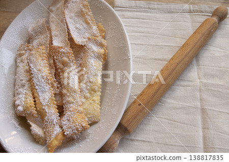 Top view of chiacchiere Italian Carnival fritters with powdered sugar Top view of chiacchiere Italian Carnival fritters with powdered sugar 138817835