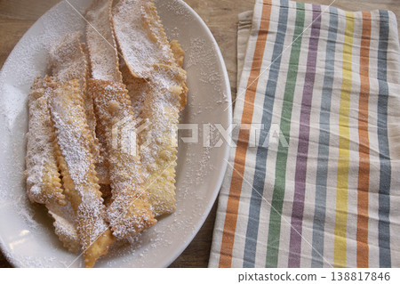 Italian Carnival fritters chiacchiere with powdered sugar on white plate 138817846