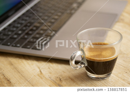 Espresso cup next to laptop screen displaying pause text for work break Espresso cup next to laptop screen displaying pause text for work break 138817851
