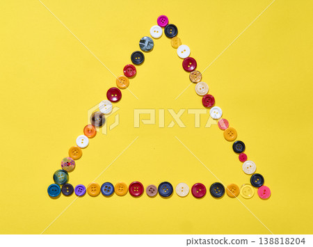 Triangle frame made of colorful buttons Triangle frame made of colorful buttons 138818204