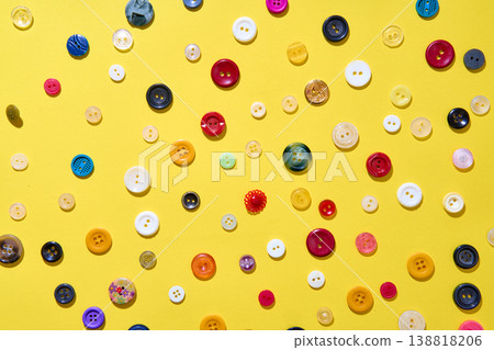 Colorful sewing buttons on bright yellow background Colorful sewing buttons on bright yellow background 138818206
