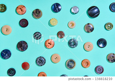 Colorful sewing buttons on bright blue background Colorful sewing buttons on bright blue background 138818210