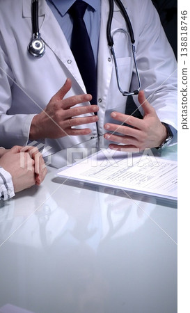 Doctor writing prescription during medical consultation, patient explaining symptoms, healthcare professional providing treatment plan, medical exam, health support Doctor writing prescription during medical consultation, patient explaining symptoms, healthcare professional providing treatment plan, medical exam, health support 138818746