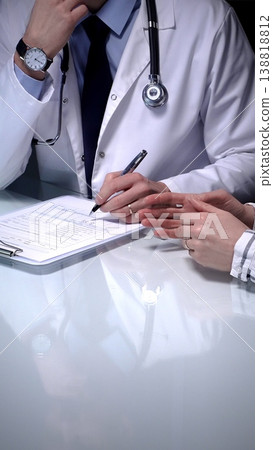 Doctor explaining medical diagnosis to a patient during a consultation, providing healthcare advice and discussing treatment options in a professional clinic setting, emphasizing health and wellness Doctor explaining medical diagnosis to a patient during a consultation, providing healthcare advice and discussing treatment options in a professional clinic setting, emphasizing health and wellness 138818812
