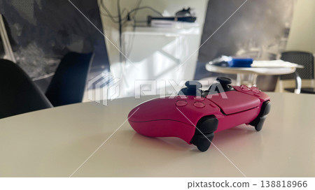 a pink joystick on the table a pink joystick on the table 138818966