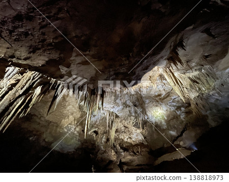 Stunning cave showcasing natural stalactite and stalagmite structures Stunning cave showcasing natural stalactite and stalagmite structures 138818973
