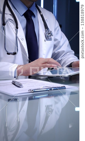 Doctor working with modern digital tablet, embracing telehealth, telemedicine, and healthcare technology for patient data management and electronic medical records 138818979