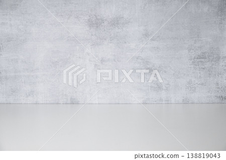 An empty white countertop against a gray concrete wall. A minimalist style on a neutral background. An empty white countertop against a gray concrete wall. A minimalist style on a neutral background. 138819043