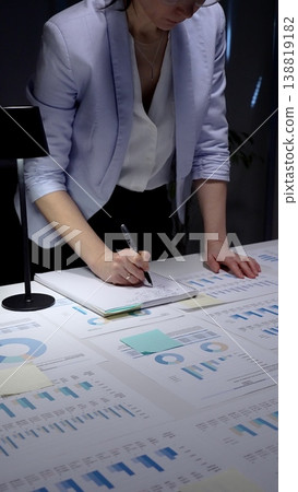 Person analyzing financial data, reviewing business analytics reports, using a laptop with charts, and planning corporate strategy with spreadsheets and investment figures Person analyzing financial data, reviewing business analytics reports, using a laptop with charts, and planning corporate strategy with spreadsheets and investment figures 138819182