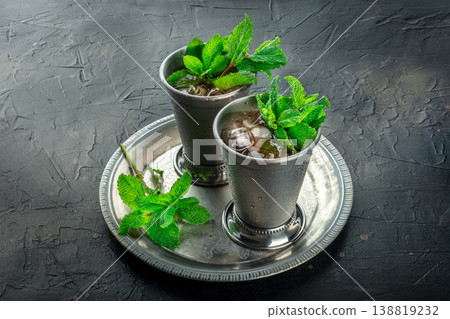 Mint Julep in the Kentucky Derby classic silver glass, with fresh mint leaves 138819232