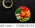 Salmon poke bowl with mango, avocado, tofu, wakame, overhead shot 138819234
