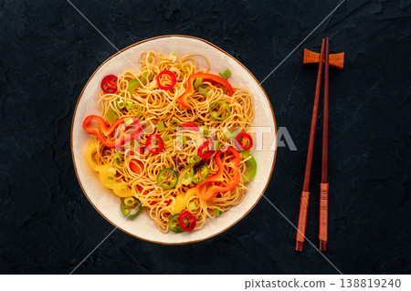 Hakka noodles with vegetables, peppers and green onions, overhead shot Hakka noodles with vegetables, peppers and green onions, overhead shot 138819240