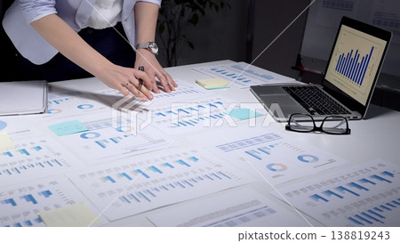 Person analyzing financial data, reviewing business analytics reports, using a laptop with charts, and planning corporate strategy with spreadsheets and investment figures Person analyzing financial data, reviewing business analytics reports, using a laptop with charts, and planning corporate strategy with spreadsheets and investment figures 138819243