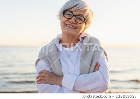 Outdoor portrait of confident stylish European middle aged senior woman. Older mature lady smiling on beach. Happy attractive senior female looking camera close up face headshot portrait. Happy people Outdoor portrait of confident stylish European middle aged senior woman. Older mature lady smiling on beach. Happy attractive senior female looking camera close up face headshot portrait. Happy people 138819553