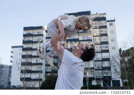Playful 4 year old girl being thrown in the air by her father outdoors Playful 4 year old girl being thrown in the air by her father outdoors 138819781