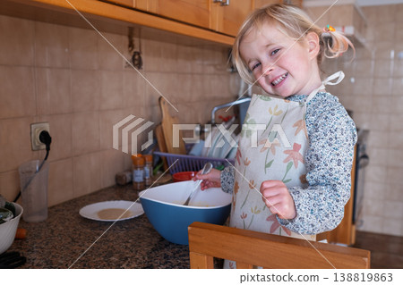 Independent preschooler: little 4 year old girl baking a homemade pie alone in a cozy kitchen 138819863