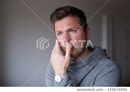 a distressed middle aged man feeling overwhelmed and stuck in a difficult situation 138819890