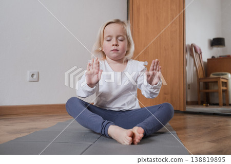 Calm child practicing mindfulness and deep breathing at home Calm child practicing mindfulness and deep breathing at home 138819895