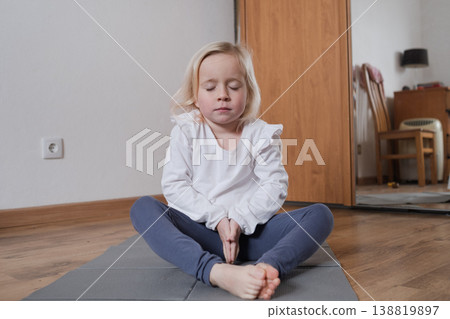 Calm child practicing mindfulness and deep breathing at home Calm child practicing mindfulness and deep breathing at home 138819897