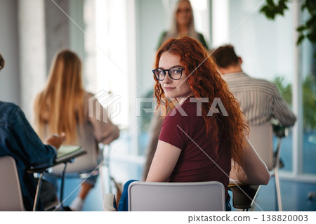 Group of college students attending lecture in university hall. Group of college students attending lecture in university hall. 138820003