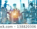 Business meeting with city skyline in background, bright light shining through large windows during the day 138820306