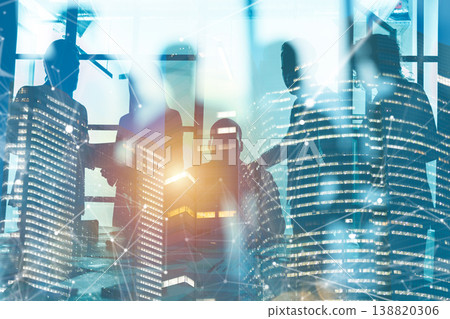 Business meeting with city skyline in background, bright light shining through large windows during the day 138820306