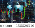 Business people discuss financial charts at night inside an office building with city lights in the background 138820310