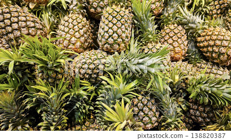 Ripe juicy pineapples at the market close-up Ripe juicy pineapples at the market close-up 138820387