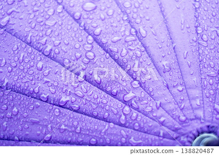 Raindrops on a purple umbrella - rainy season - rain image Raindrops on a purple umbrella - rainy season - rain image 138820487