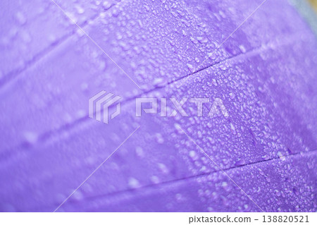 Raindrops on a purple umbrella - rainy season - rain image Raindrops on a purple umbrella - rainy season - rain image 138820521