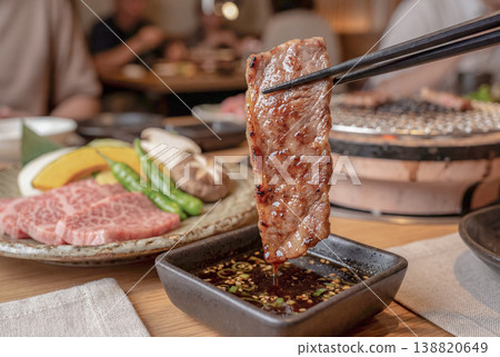 A scene where you dip the food in the sauce and eat it. 138820649