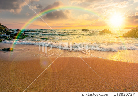 sunset over sandy sea beach. scene on hot summer vacation season. beautiful view of waves washing the sand. generic image of seascape and sky with rainbow for advertising background sunset over sandy sea beach. scene on hot summer vacation season. beautiful view of waves washing the sand. generic image of seascape and sky with rainbow for advertising background 138820727