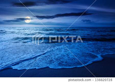 autumn vacation at the sea at night. full moon over beautiful seascape. calm waves wash the sandy beach. image with cloudy sky above horizon. mysterious background for fantasy or ads placement autumn vacation at the sea at night. full moon over beautiful seascape. calm waves wash the sandy beach. image with cloudy sky above horizon. mysterious background for fantasy or ads placement 138820728