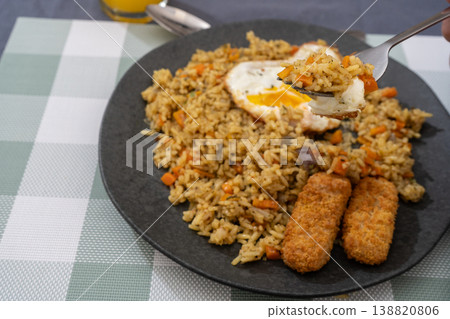 Golden Rice with Fish Fingers and Fried Egg Golden Rice with Fish Fingers and Fried Egg 138820806