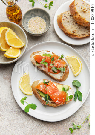 Salmon bruschetta with cream cheese and avocado slices 138820916