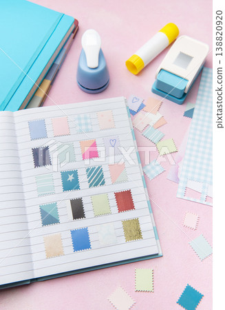 Scrapbook journal with decorative crafting paper punches creating diy stamps Scrapbook journal with decorative crafting paper punches creating diy stamps 138820920