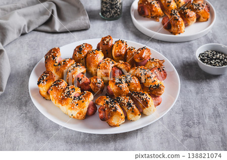 Homemade sausages in sesame dough on a plate on the table 138821074