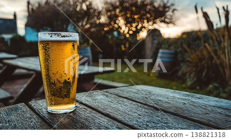 Refreshing Cold Beer on a Wooden Table in a Beer Garden 138821318