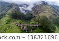 Ancient Railway Bridge Through Misty Green Mountains with Forest 138821696